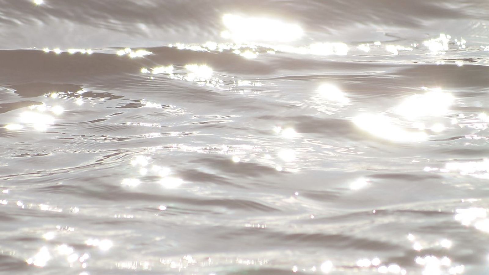 Low sunlight scattering across the surface of still water.